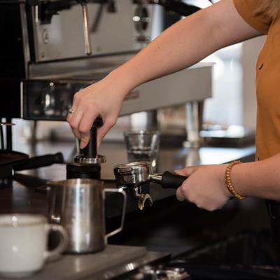 Hands preparing coffee.