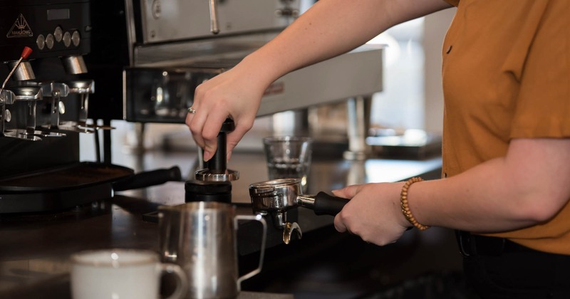 Hands preparing coffee