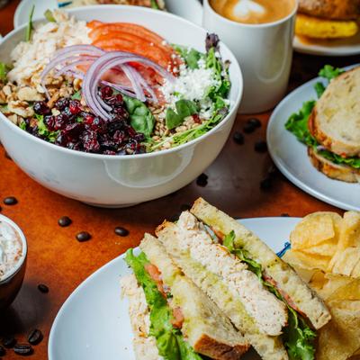 Italian Chicken sandwich served alongside Craisin Chicken salad and other dishes.