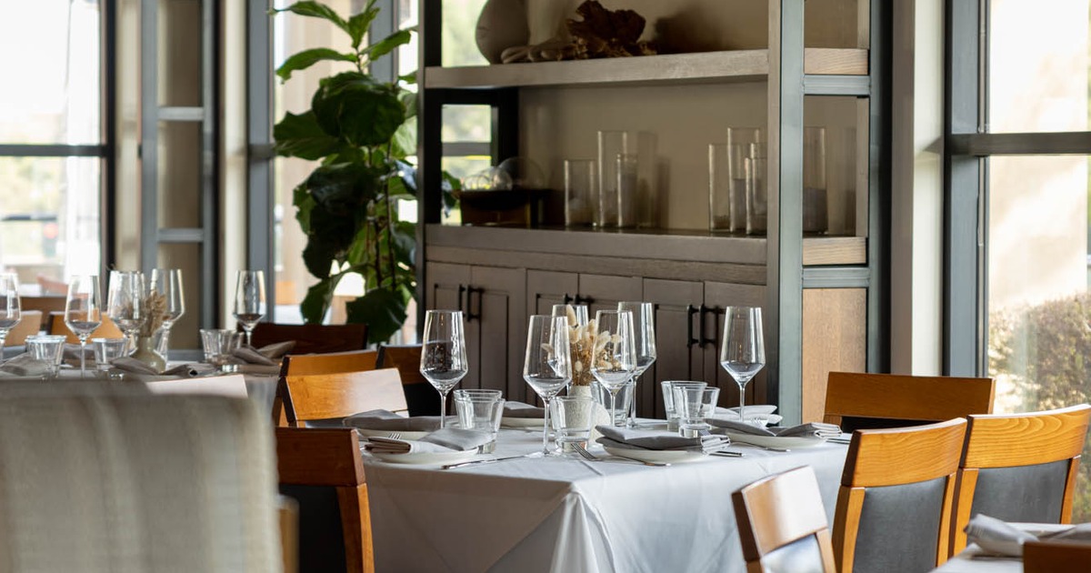 Interior, tables with tableware, cutlery and glasses