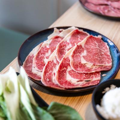 Thinly sliced meat on a plate.