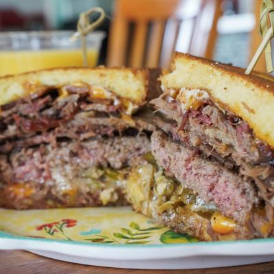 A cross-section of a burger with melted cheese and jalapenos.
