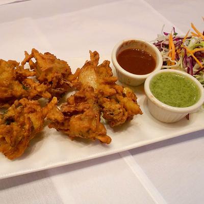 Assorted vegetable fritters, with dipping sauces and salad.