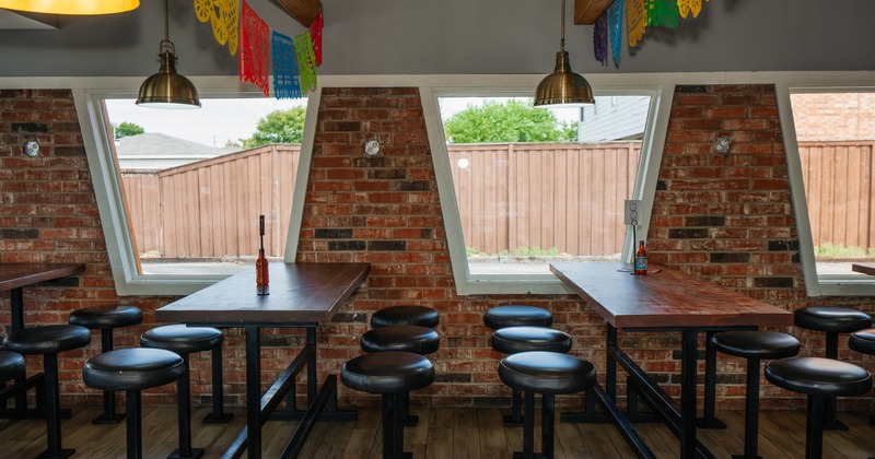 Seating area with high tables and round stools