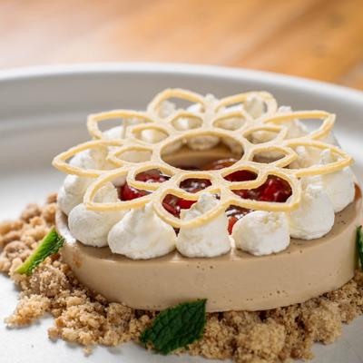 Roasted White Chocolate Chestnut Panna Cotta on gray plate.