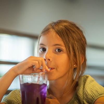 A guest drinking a beverage on a straw.