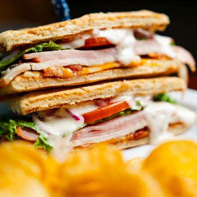 Signature Club Sandwich with a side of chips.