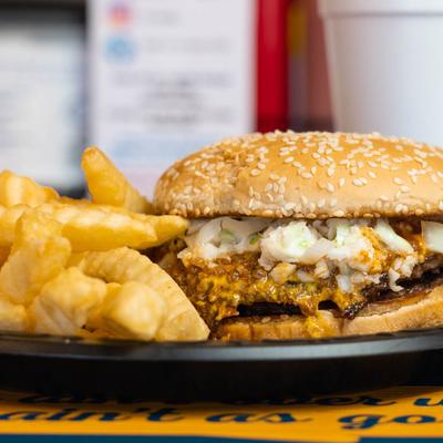 Deluxe Cheeseburger with mustard, chili, slaw and onions!.