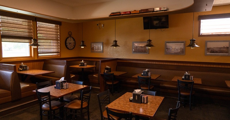 Interior, dining area, banquette bench with tables and chairs, seating booths, carpet flooring