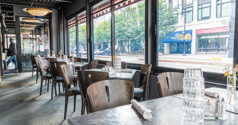 Interior, lined up tables by windows ready for guests