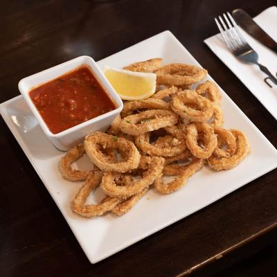 Fried squid, served with marinara and lemon wedge.