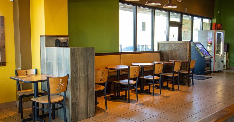 Interior, waiter serving station, long banquette bench with tables and chairs, back entrance