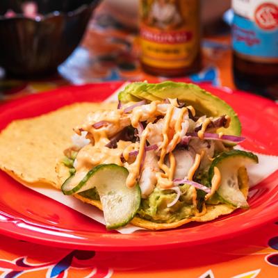 Crispy tortilla topped with shrimp, octopus, avocado, and cucumbers.