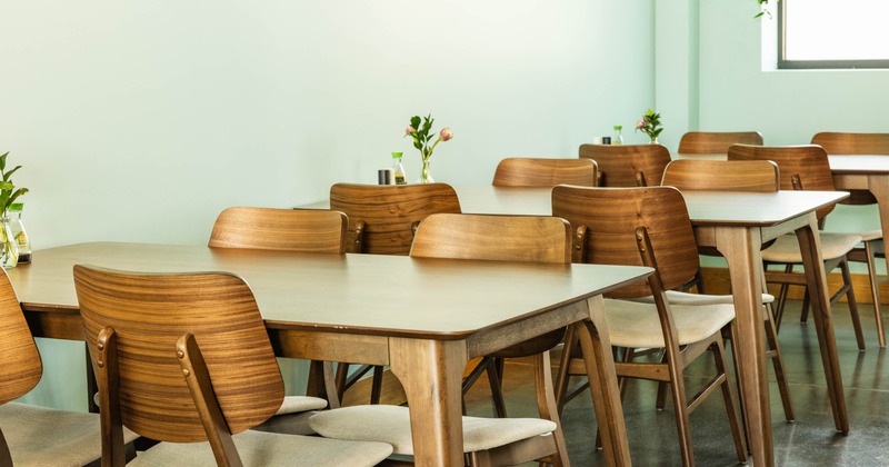 Interior, dining area, closeup on the modern and stylish tables for four people