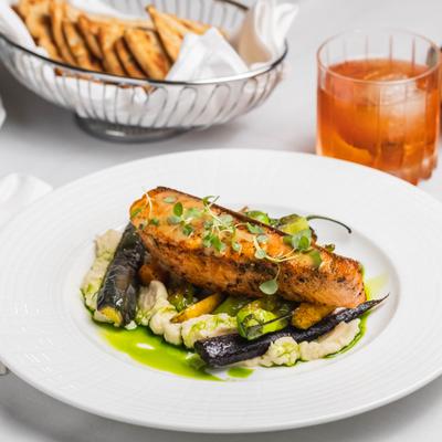 Grilled salmon with celery root puree, shishito peppers, roasted baby carrots, and a cocktail.