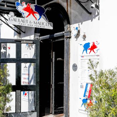 Exterior, restaurant front entrance, with a menu attached to the wall
