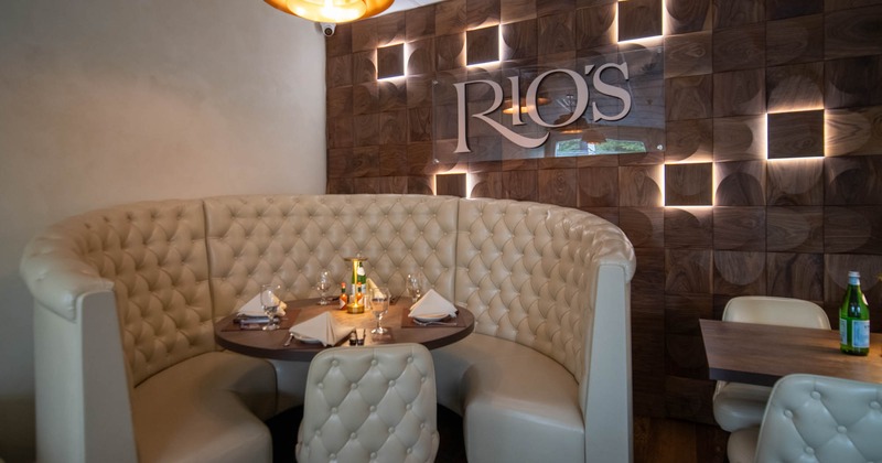Interior, restaurant booth with a round table, tufted seating
