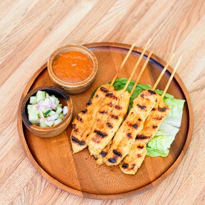 Chicken Satay served with homemade peanut sauce and cucumber salad.