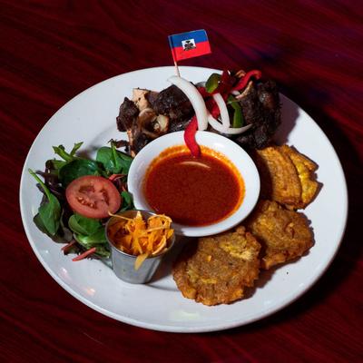 Beef, with salad, mofongo, and sauce.