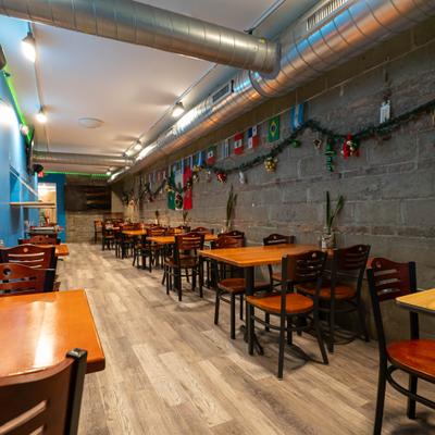 Restaurant dining room with wooden tables and wall decorations.