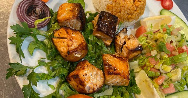 Grilled chicken platter with rice, salad and vegetables