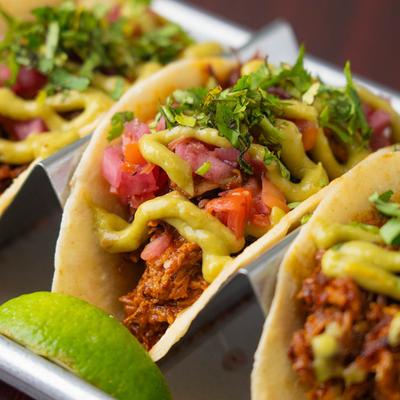 Marinated pork tacos, with pickled habanaro peppers, onion, cilantro, and avocado salsa.