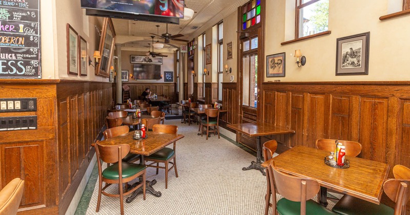 Retro interior, tables of various sizes, walls decorated with vintage pictures