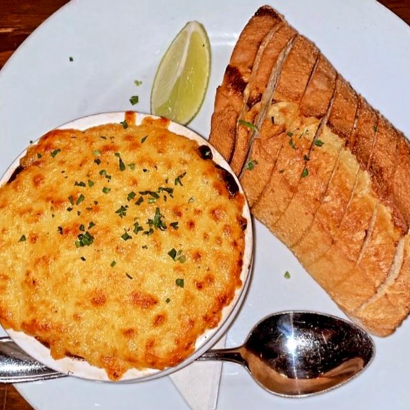 Oven fired bay scallops in a spicy lime mornay sauce and regianito served with macrina baguette photo