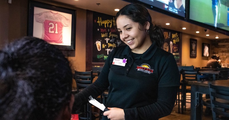 Smiling waitress at a table