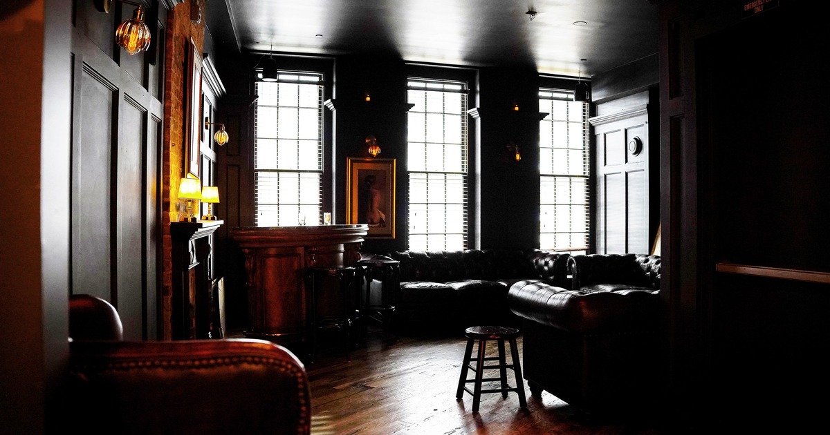Stylish, dimly lit interior lounge seating area with a warm and cozy atmosphere