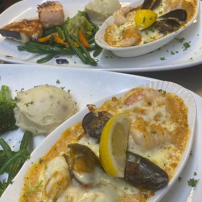 Fresh Seafood Bake. Shrimp, scallops and mussels in creamy sun dried tomato pesto..