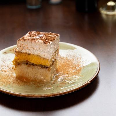 Cake with pineapple, pudding, whipped cream, and cinnamon.