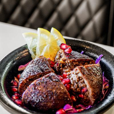 Coal grilled Kebbeh topped with pomegranate molasses.