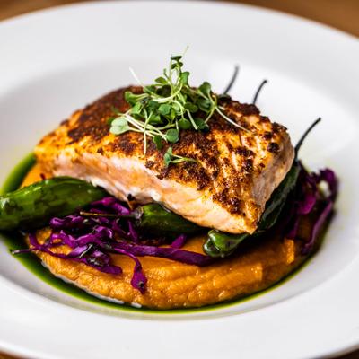 Blackened Salmon, with mashed sweet potatoes, red cabbage slaw, and shishito peppers.