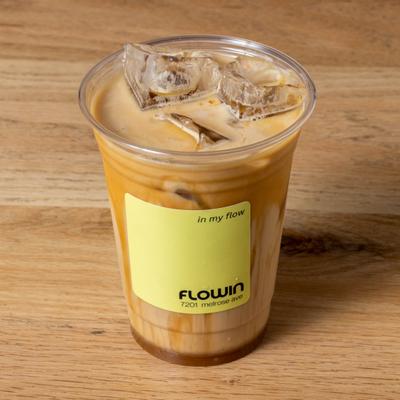 Iced Sea Salt Caramel Latte served in a labeled plastic cup.