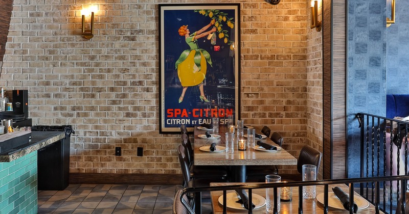 Interior, dining area, tables ready for guests, red brick wall, large format vintage poster