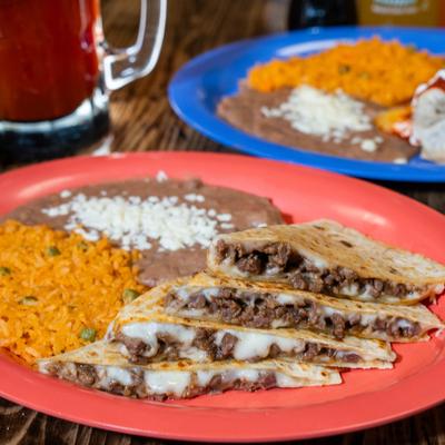 Steak and cheese quesadillas, served with rice and beans.