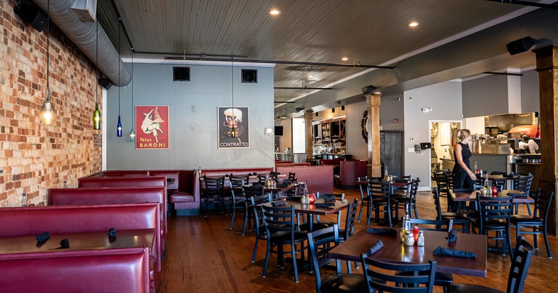 Spacious dining area with booths along the wall and tables and chairs