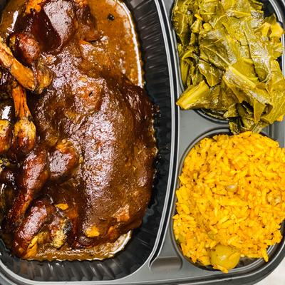 Jerk salmon and shrimp served with collard greens and yellow rice.