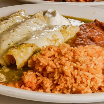 Enchiladas smothered in green salsa and cheese, served with rice, beans, and sour cream.