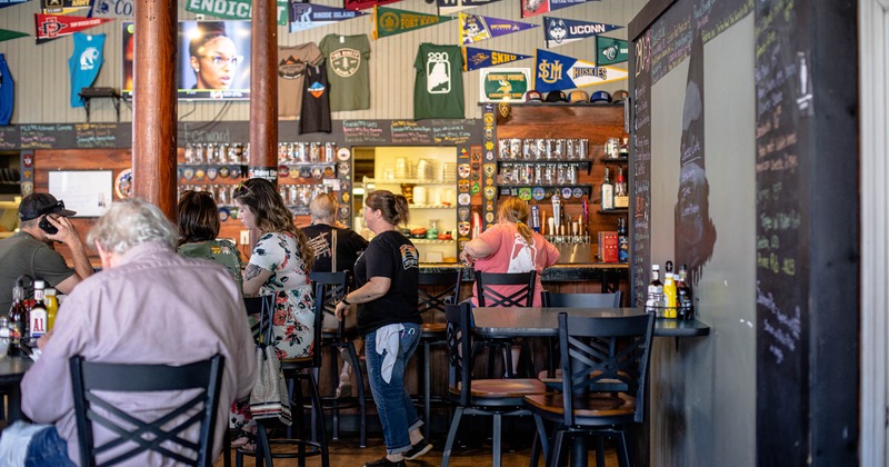 Interior, guests and staff in the bar area