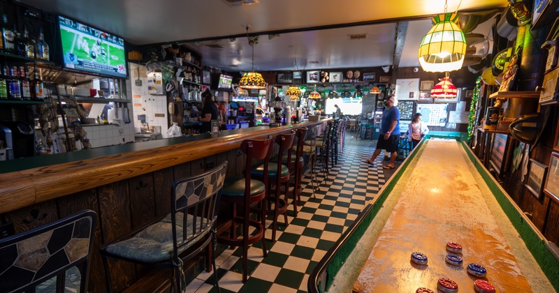 Bar area, chairs, drink rack behind