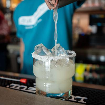 Bartender pouring a cocktail.