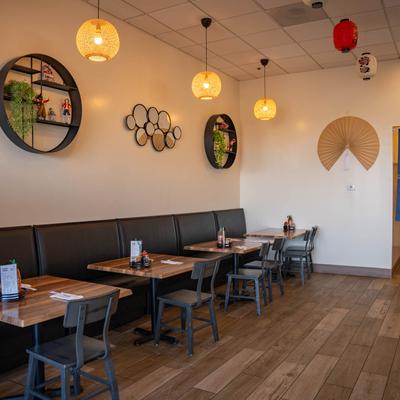 Dining tables lined up against a decorated wall.