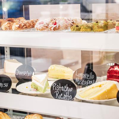 Dessert display case with assorted cakes and pastries.