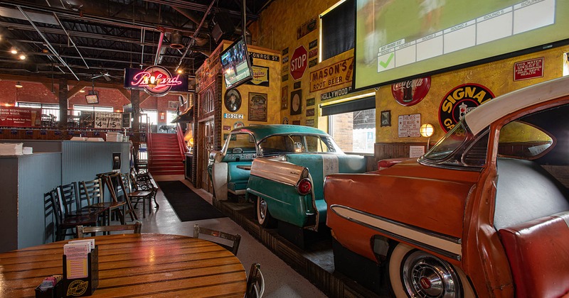 Interior, car with seats for guests on the right side, tv screen on the wall