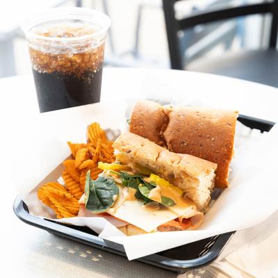 Red Bird sub accompanied with a cup of cola.