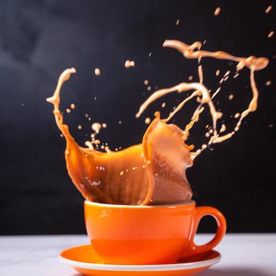 A coffee splashing in a cup.