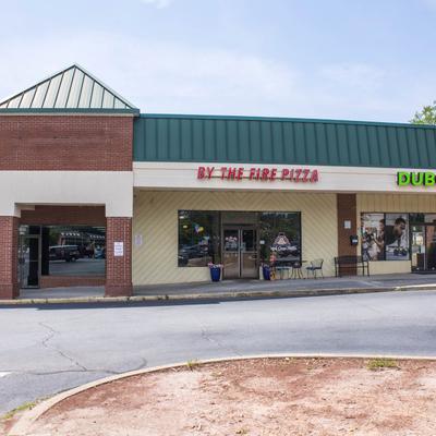 Exterior with signage and outdoor seating.