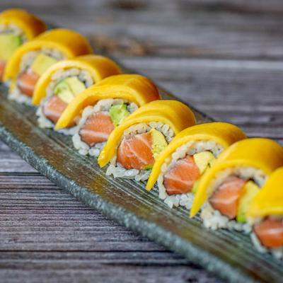 Salmon rolls, topped with mango.